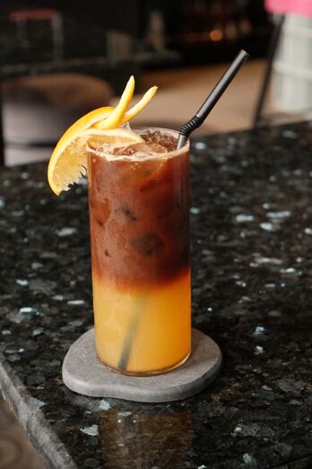 Signature coffe drink in hi-ball glass with straw